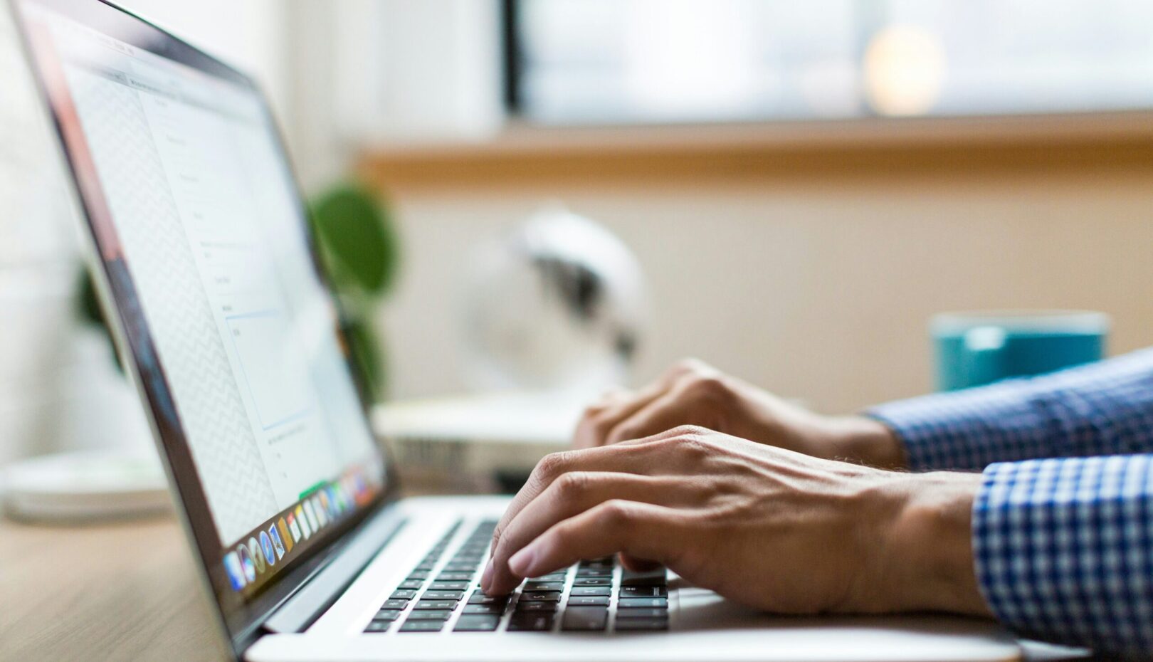 person typing on silver Macbook
